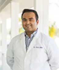 Portrait of a smiling young woman with curly hair.